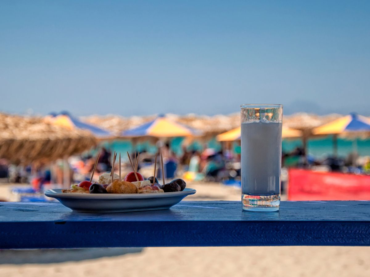 A glass of Greek ouzo with meze