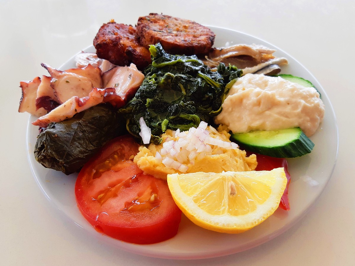 A meze plate with horta in Greece