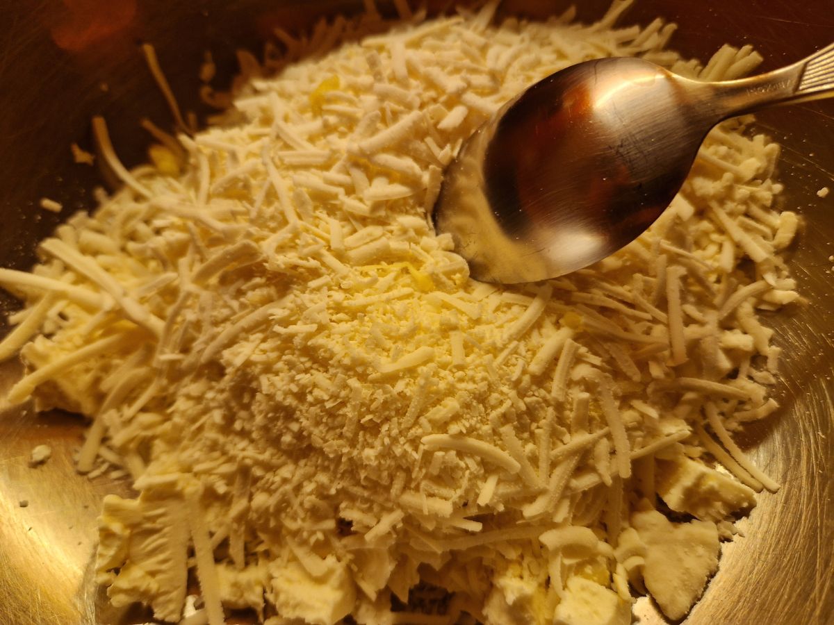 Easy tiropita recipe - a bowl with feta and grated cheese 